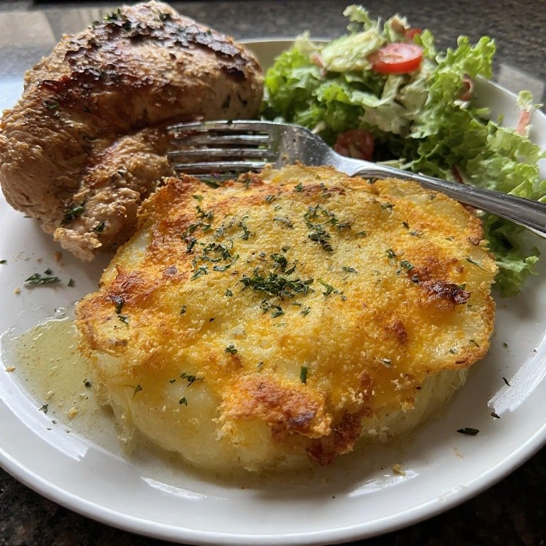 Plated cheesy garlic potatoes gratin
